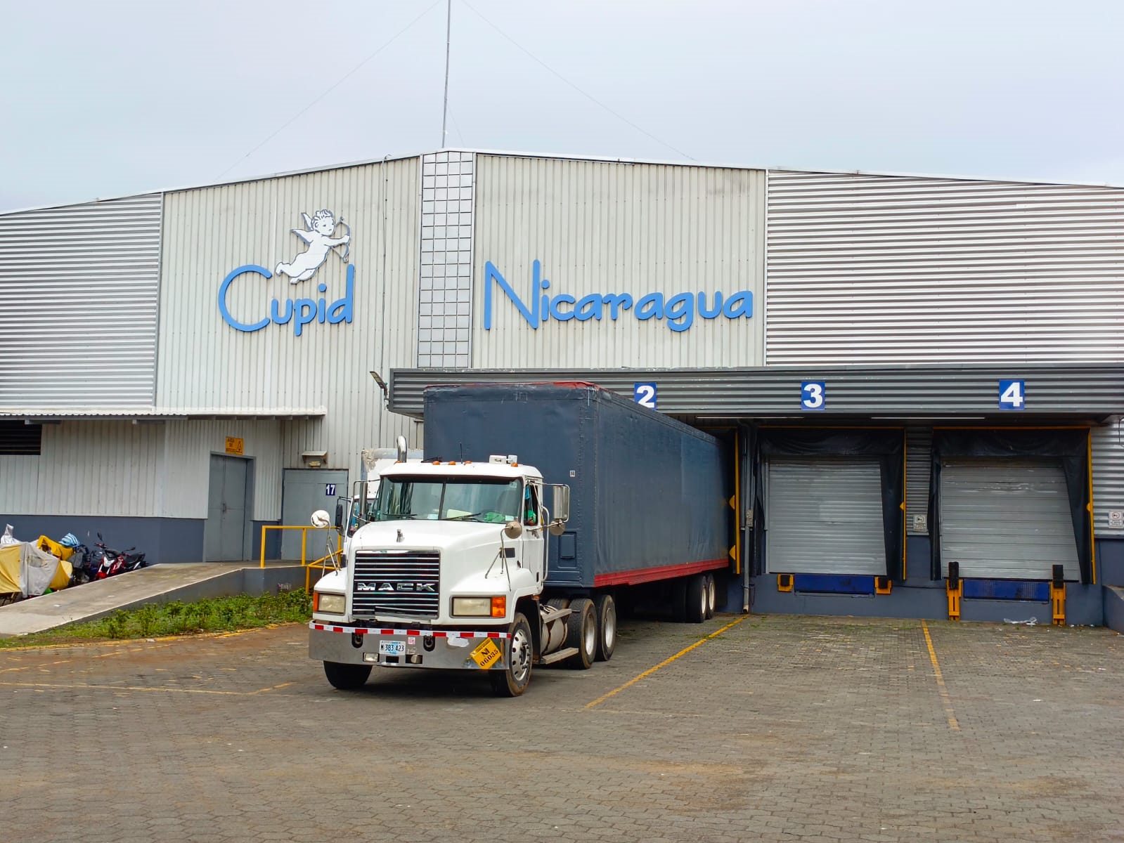 The A&T Nicaragua plant in Masaya, with a trailer at the loading docks beneath the Cupid Nicaragua signage.