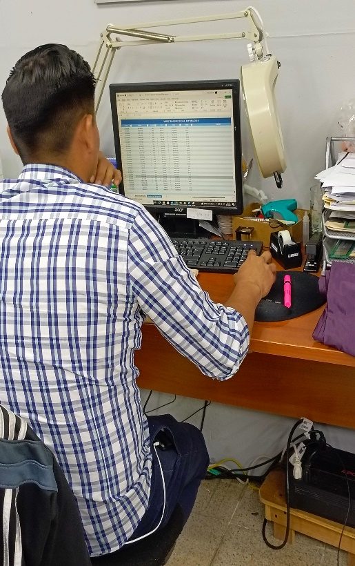 A technician entering measurement data at a quality workstation.