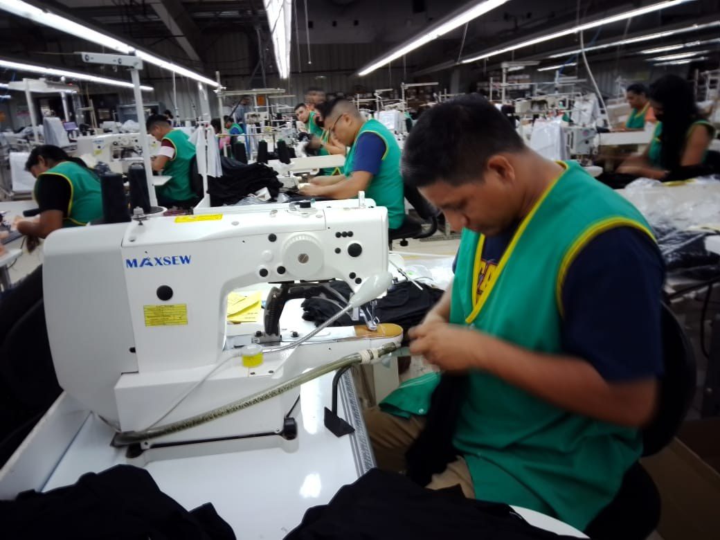 Operators at sewing stations across the A&T Nicaragua production floor.